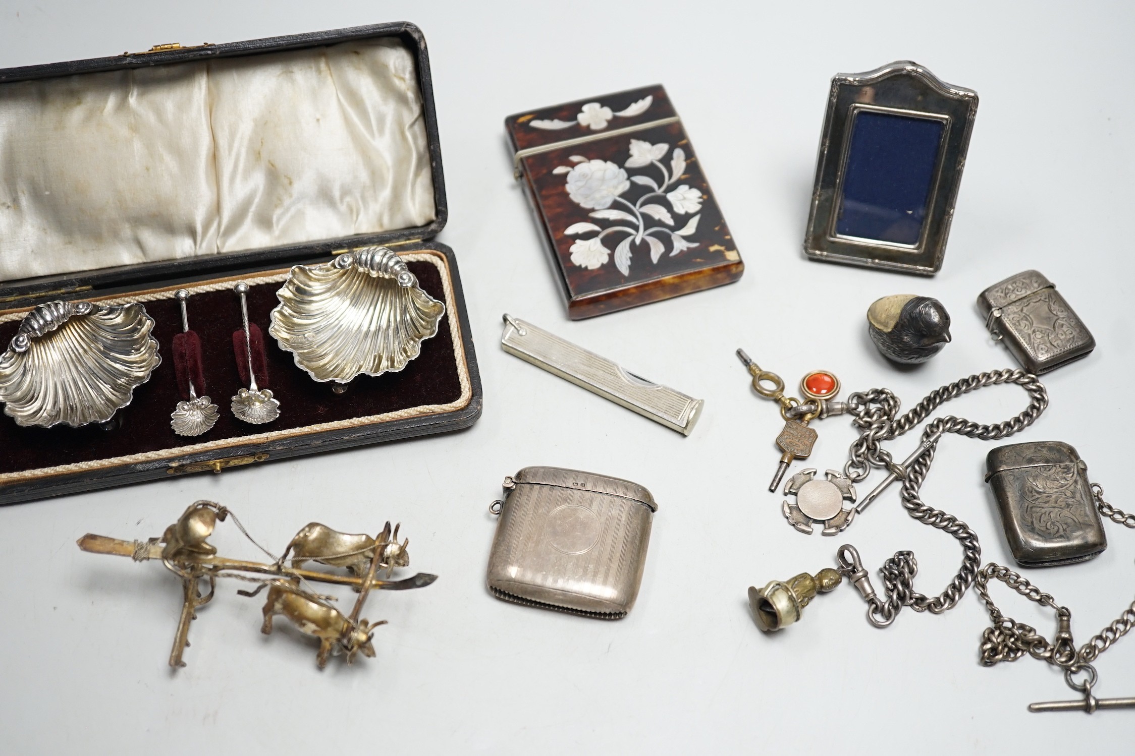 A cased pair of Edwardian silver shell salts, with spoons, and other items including Edwardian silver mounted bird pin cushion, by Sampson Mordan & Co, vesta cases, inlaid tortoiseshell card case etc.